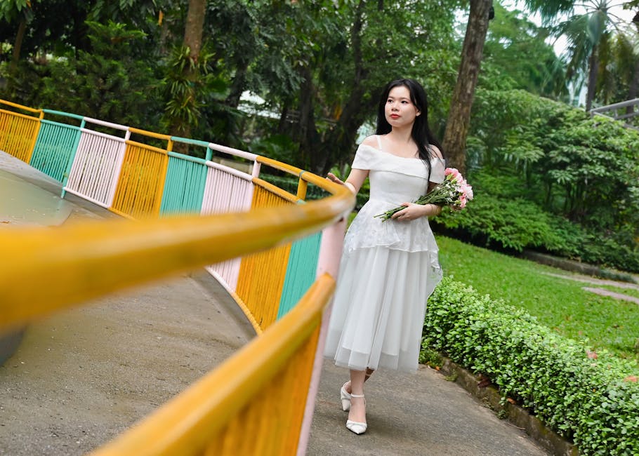 Woman in elegant white dress on a colorful bridge